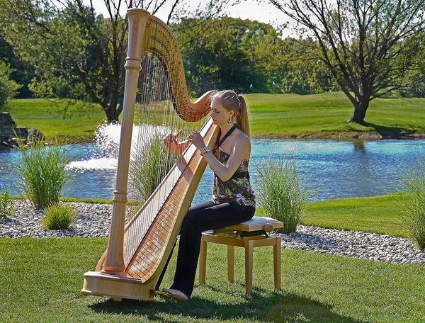Young woman playing a harp