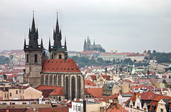 Prague historical centre with rooftops and towers of Tynsky church and Prague castle on the horizon. This shot was taken in summer.