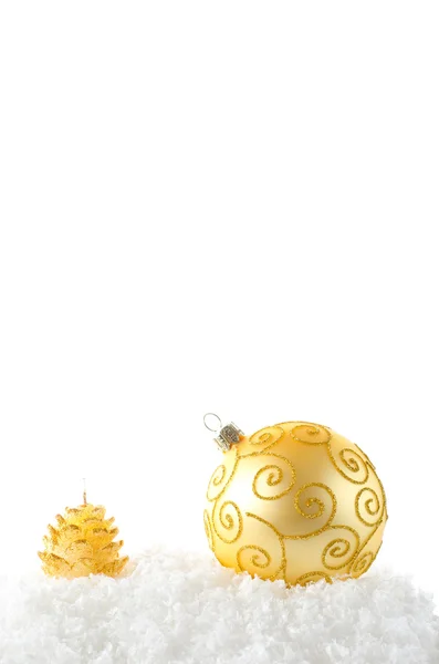 A gold ball and cande on snow — Stock Photo, Image