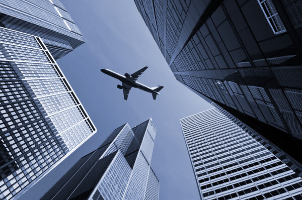 Image of airplane flying above Chicago downtown district.