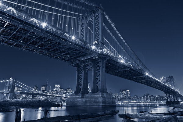 Image of Manhattan Bridge with Brooklyn Bridge and Manhattan skyline in the background.