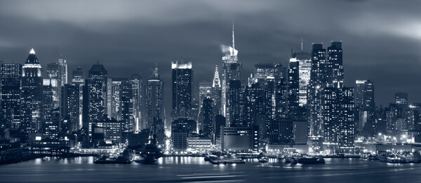 Panoramic image of Manhattan skyline at night.