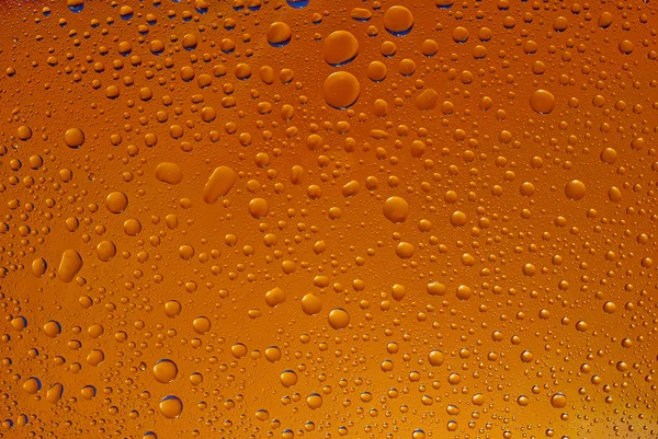 Vatten droppar, orange färg, bakgrund — Stockfoto