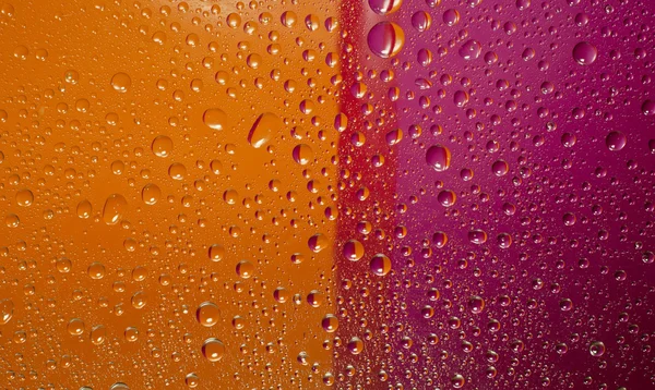 Vatten droppar, orange och magenta färger, bakgrund — Stockfoto