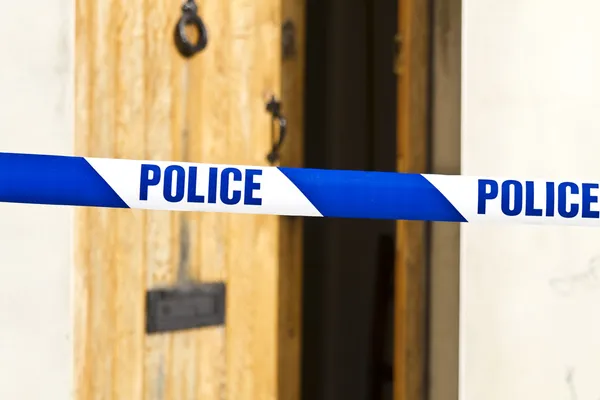 stock image Police tape across an open door