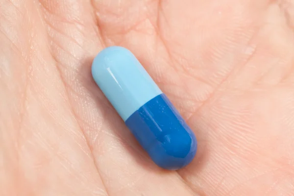Capsule in a hand — Stock Photo, Image