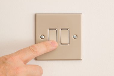 Double Lightswitch on a White Wall being pressed clipart