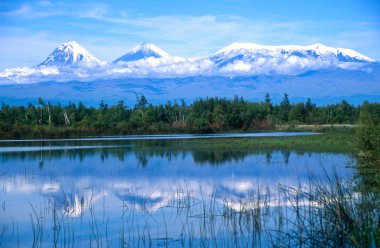 Kamchatkan volcanoes mirrored in a lake clipart