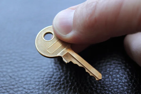 Gold key in man hand — Stock Photo, Image