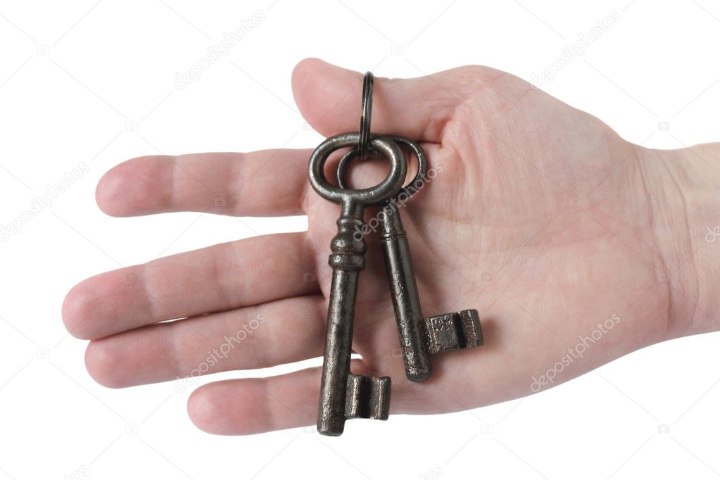 Old keys in man hand isolated on white background