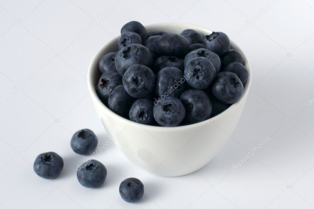 Blueberries in a cup isolated on white