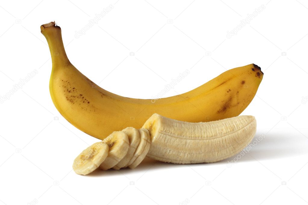 Ripe banana cut into slices and one whole on a white background