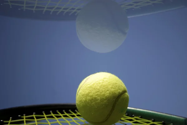 Tennis ball on racket — Stock Photo, Image