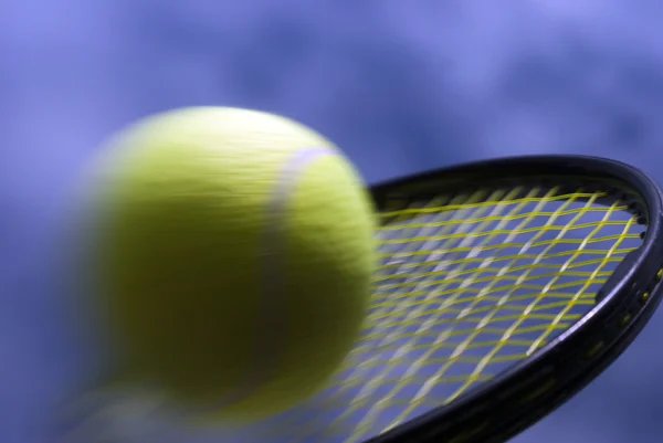 Speedy tennis ball on racket — Stock Photo, Image