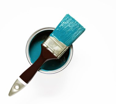 Turquise painted brush on a paint bucket