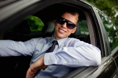 Young man in the car clipart