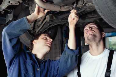 Two Car Mechanic repairing car clipart