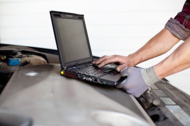 Car mechanic with laptop clipart