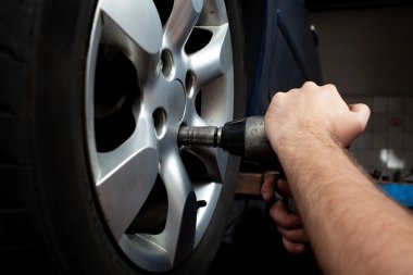 Changing wheel on car clipart