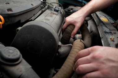 Closeup of mechanic repairing car clipart