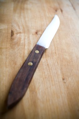 Knife and a Cutting Board with selective focus clipart