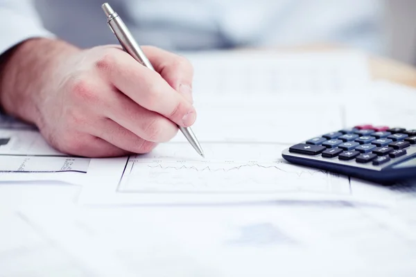 Financial data analyzing. Counting on calculator. — Stock Photo, Image