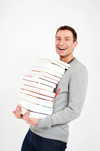 Estudante feliz com uma pilha de livros — Fotografia de Stock