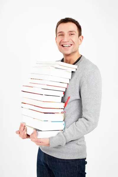 Счастливый студент с пачкой книг — стоковое фото