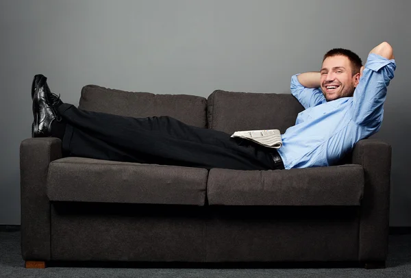 Businessman laying on sofa — Stock Photo, Image
