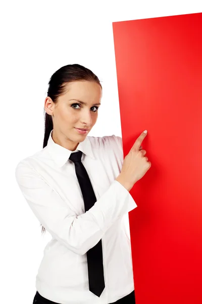 Woman pointing at red billboard — Stock Photo, Image