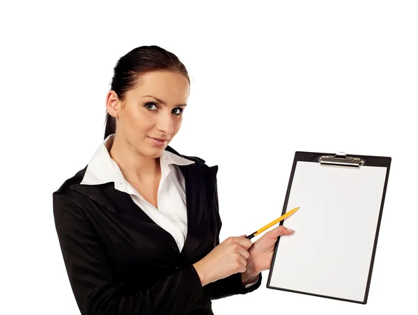 Businesswoman pointing on clipboard — Stock Photo, Image