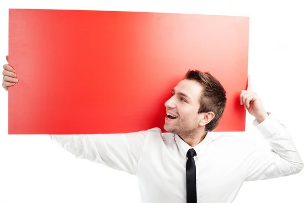 Glad affärsman med blank röd skylt — Stockfoto