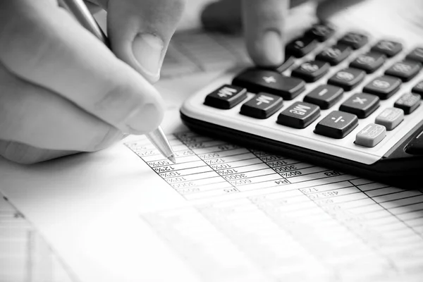 Financial data analyzing. Counting on calculator — Stock Photo, Image