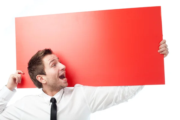 Businessman with red billboard screaming — Stock Photo, Image