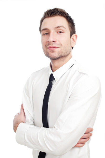 Young Businessman standing with his arms crossed isolated on white. He's smiling lightly