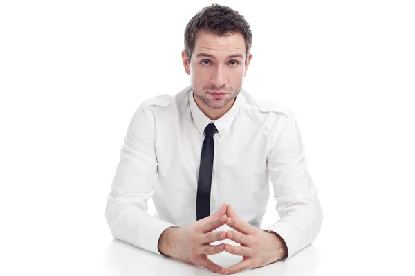 Young Businessman sitting at the desk with serious face — Stock Photo, Image