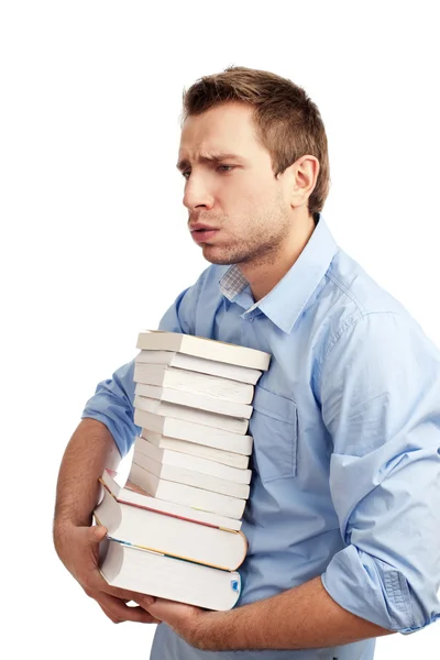 Уставший студент держит книги — стоковое фото