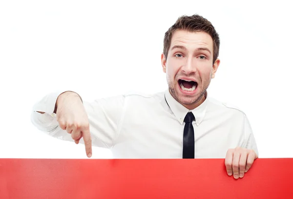 Angry businessman pointing at billboard — Stock Photo, Image