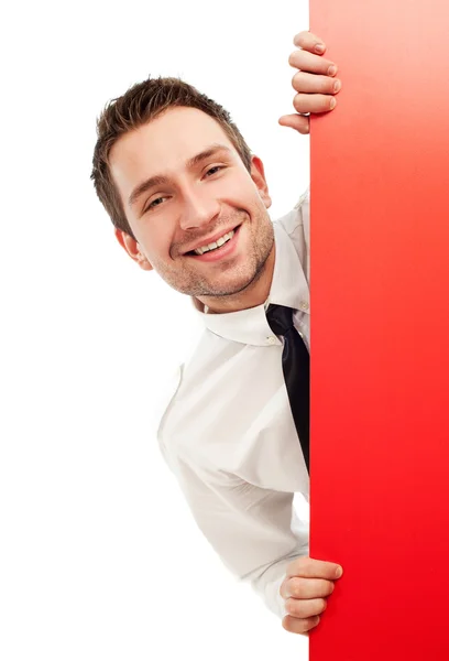 Curious businessman behind red sign — Stock Photo, Image