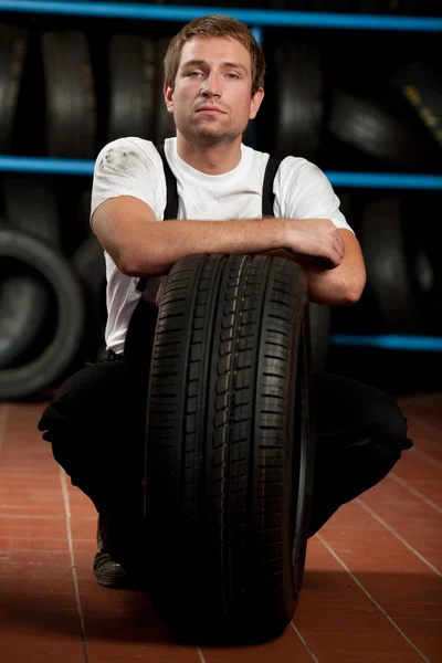 Mechanic with tyre — Stock Photo, Image