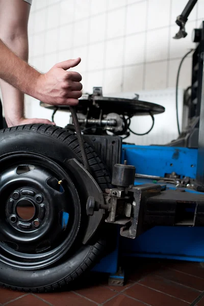 Mechanik mění záběr pneumatik automobilu — Stock fotografie