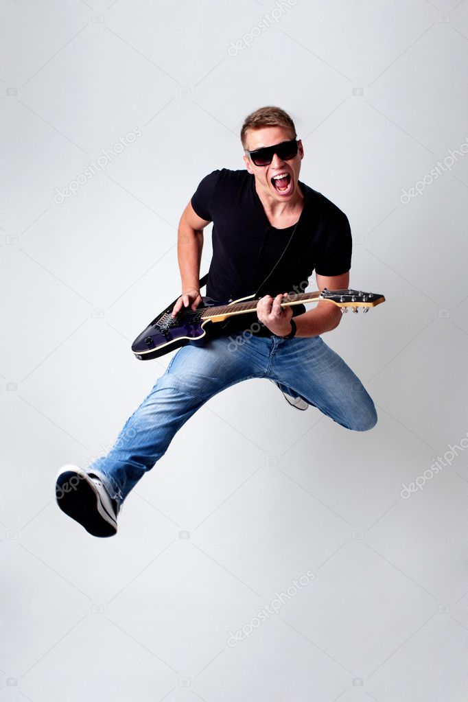 Rockstar leaping with guitar
