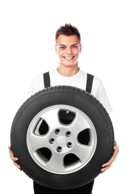 Auto mechanic holding car wheel clipart