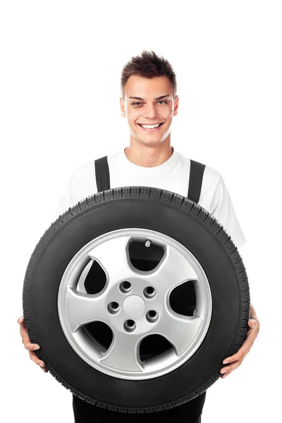 Auto mechanic holding car wheel — Stock Photo, Image