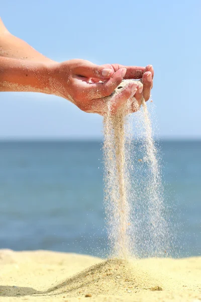 stock image Hand pours the sand