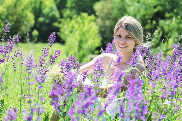 Młoda kobieta w pobliżu kwiaty bzu — Zdjęcie stockowe