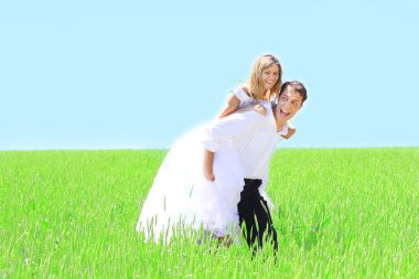 Newlyweds in a field of wheat clipart