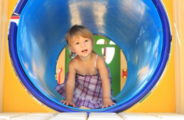 Little girl crawling in a tube clipart