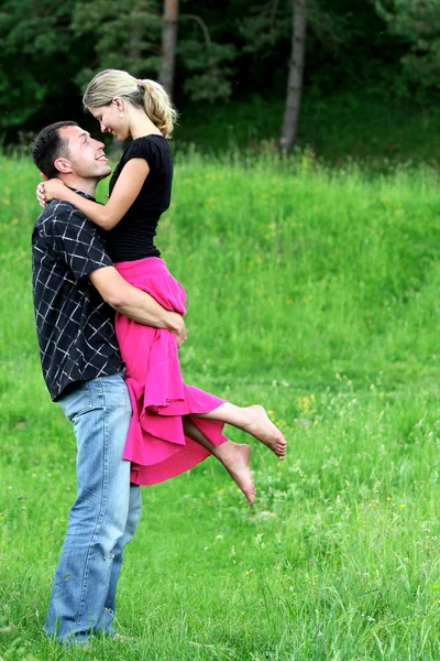 A young couple in love on the field — Stock Photo, Image