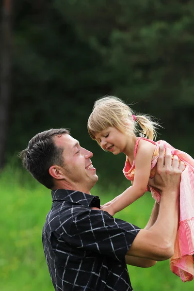 Beautiful little girl with her dad on the nature — Stock Photo, Image